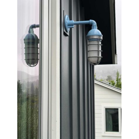 Industrial Guard Sconce, 715-Delphite Blue PTMP, CGG-STandard Cast Guard in 975-Galvanized, Frosted Glass | Photo Courtesy of Studio Baron