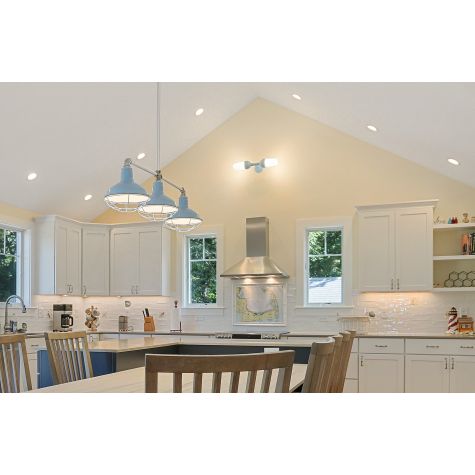 Atomic Topless Double Industrial Guard Sconce, 715-PTM Delphite Blue, WGG-Wire Guard, Frosted Glass (Also pictured: Dino 3-Light Stem Mount Pendant) | Photo Courtesy of Build with Coastal in Eastham, Massachusetts